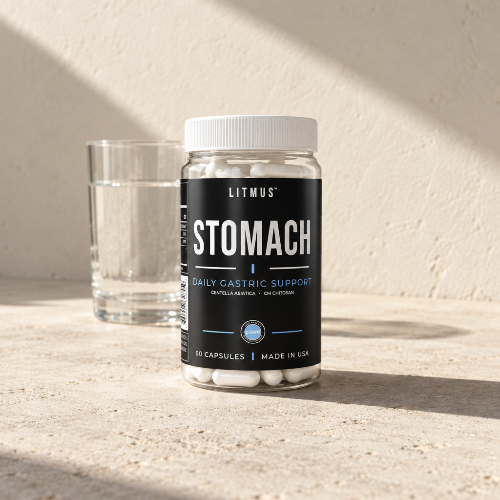 A STOMACH jar on a stone counter in sunlight, beside a glass of water.