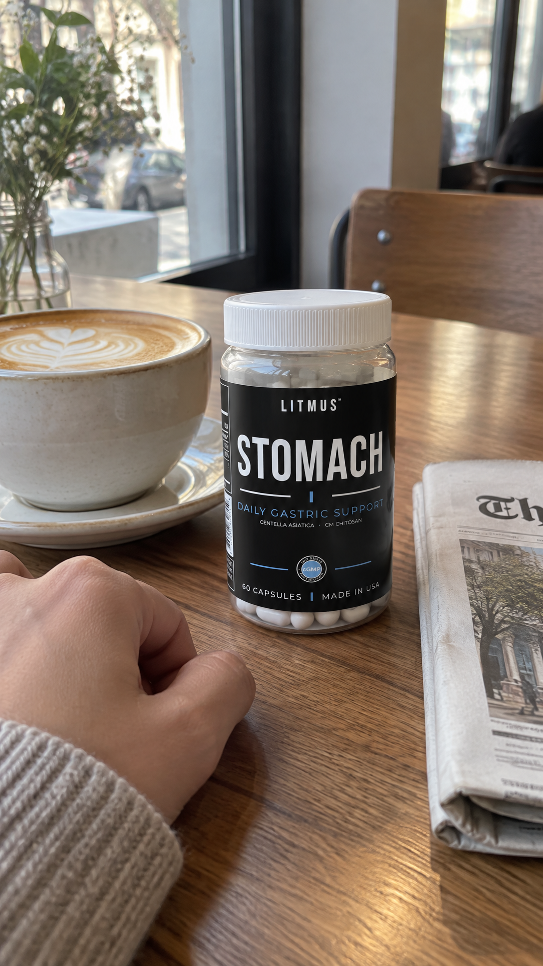 LITMUS STOMACH jar on a cafe table beside a drink.